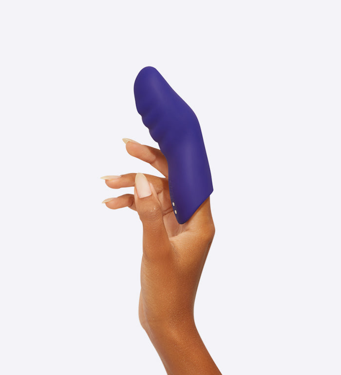 The FemmeFunn Dioni slid on top of a finger to be used for pleasure. This is the size small. It looks like an extra-large version of the person's own fingers. | Kinkly Shop