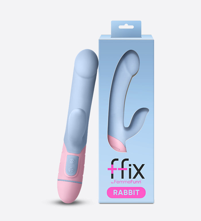 The FemmeFunn FFIX Rabbit vibrator leaned up against its packaging. The packaging is basic and modern with a window to see the vibrator when viewing from outside the box. | Kinkly Shop