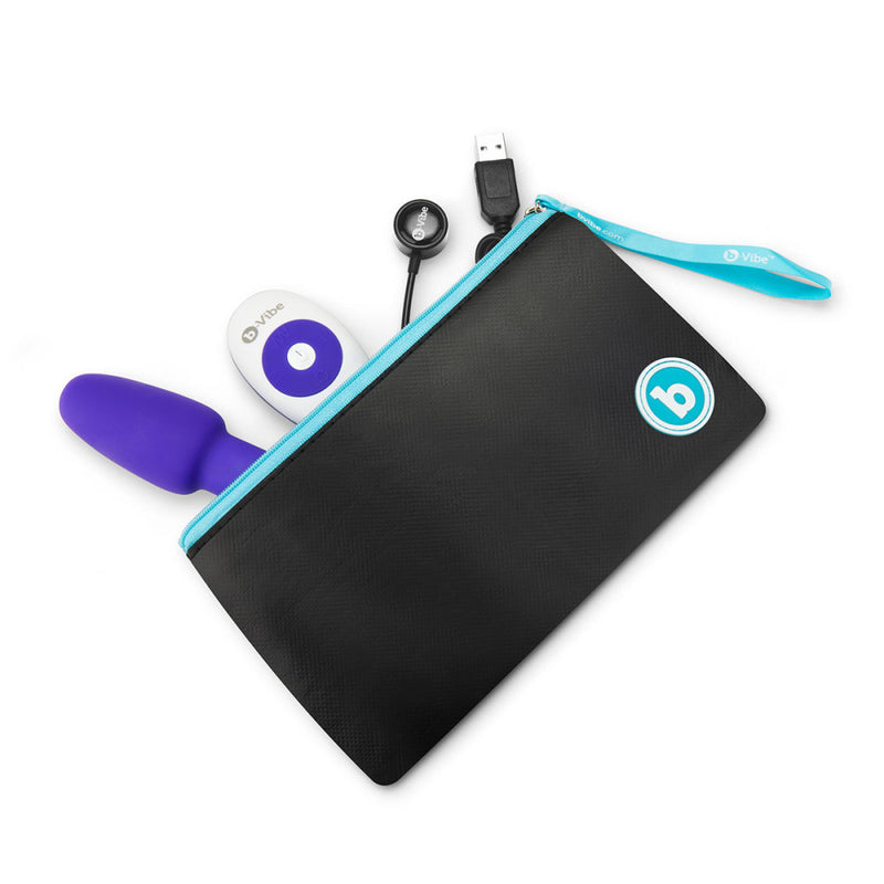 The pouch included with the b-Vibe Petite Rimming Plug laying unzipped on its side. Everything that comes with the b-Vibe Petite Rimming Plug is inside of the pouch. It showcases how large and spacious the pouch it; it has a lot of room to spare, and it could fit a lube bottle or other accessory items. | Kinkly Shop
