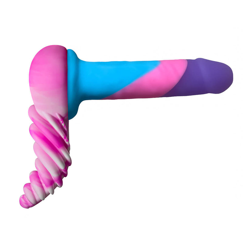 The LuvGrind dildo base pressed up against the base of a colorful dildo. This side profile showcases how the LuvGrind wraps underneath the body while worn. | Kinkly Shop