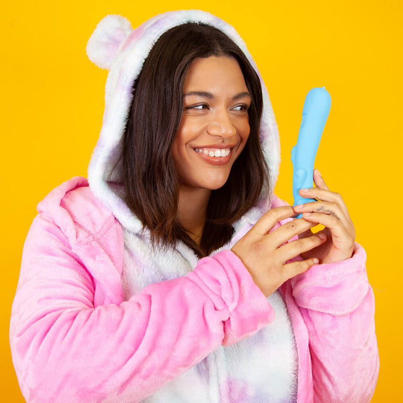 A person in a fluffy onesie holds the Cute Little Fuckers Trinity up near their face. They're smiling at it. They have very relaxed body language. | Kinkly Shop