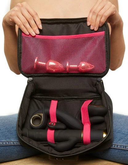 A person holds the Dorcel Discreet Box up in front of their topless chest. There are toys inside the bag. | Kinkly Shop