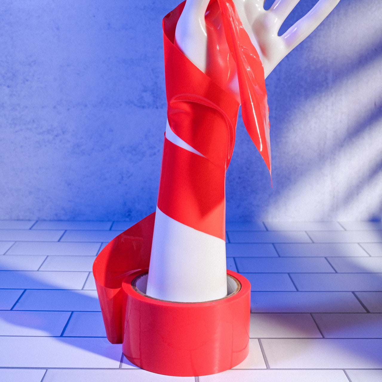 Red Evolved Bondage Tape wrapped around the mannequin hand, showcasing how thin and flexible the tape is. | Kinkly Shop