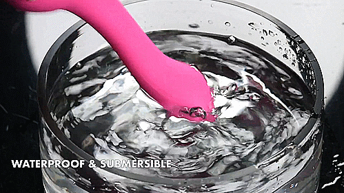 GIF shows a person holding the tip of the Evolved Gyro Vibe into a large bowl of water. The vibrator is making a ton of movement in the bowl of water, and no area of the water is staying still. It does not seem to be splashing much of the water outside of the bowl, though, unlike the the usual vibrator. Text on the image reads "Phthalate and Latex Free" | Kinkly Shop