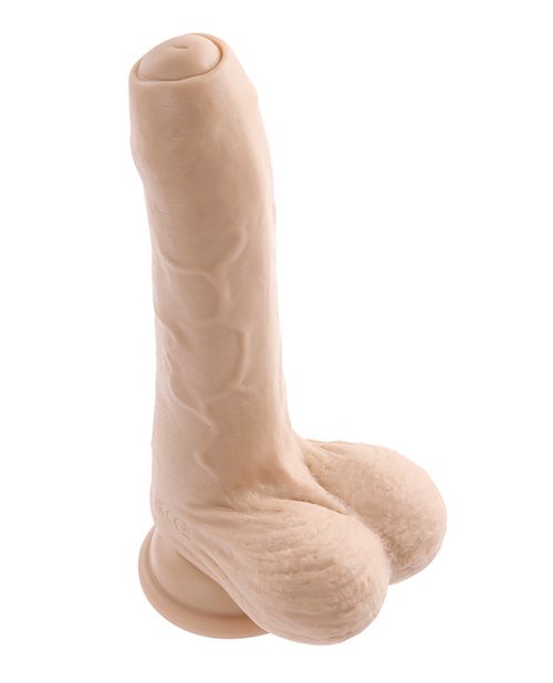 A 3/4ths view of the Evolved Peek a Boo Vibrating Dildo. This showcases the realistic uncircumsized tip which allows the urethral opening to peep out from underneath the foreskin. The shaft of the dildo has textured veins. | Kinkly Shop