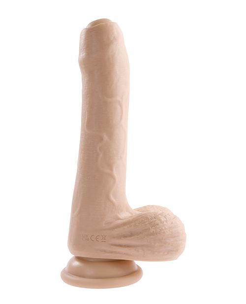 A side view of the Evolved Peek a Boo Vibrating Dildo. The head of the dildo is uncircumsized and the testicles protrude from the base of the shaft. There's a large, plushy suction cup at the very base. | Kinkly Shop
