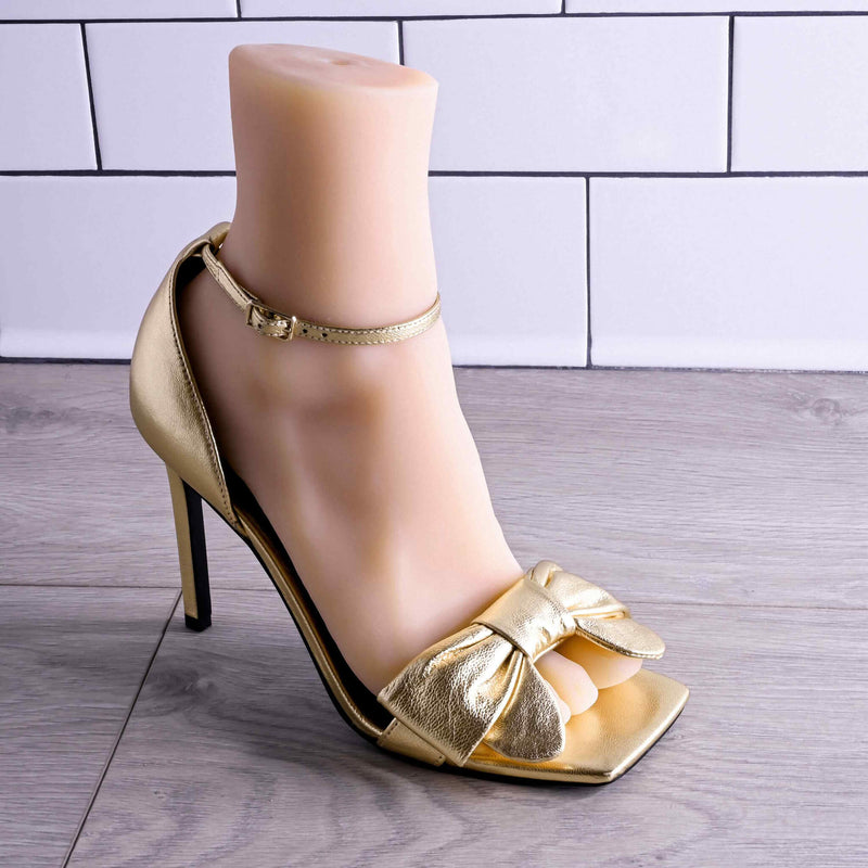 The Evolved Pussy Footin' in Cream within a gold high heeled shoe. It looks extremely realistic within the shoe. | Kinkly Shop