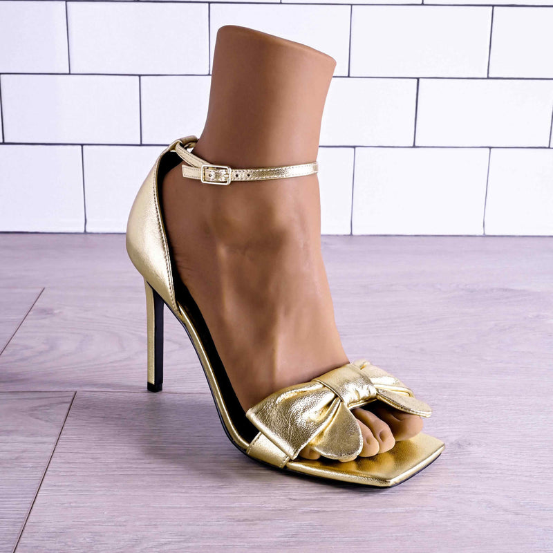 The Evolved Pussy Footin' in Espresso within a gold high heeled shoe. It looks extremely realistic within the shoe. | Kinkly Shop