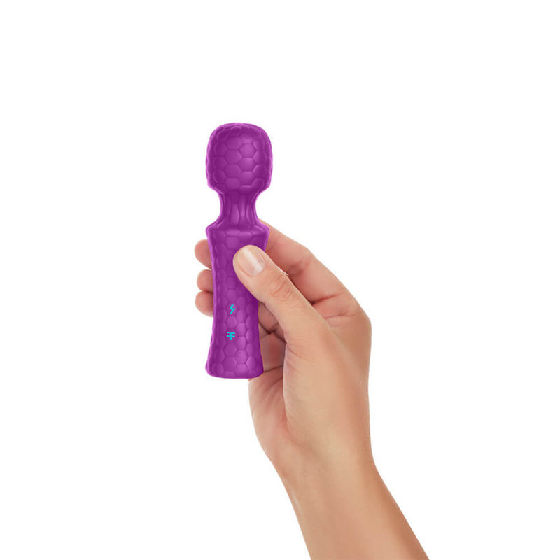 A hand holds the FemmeFunn Ultra Wand Mini in Purple against a white background. The wand massager looks surprisingly short in height, and it is barely longer than the person's hand. It looks adorably tiny. | Kinkly Shop