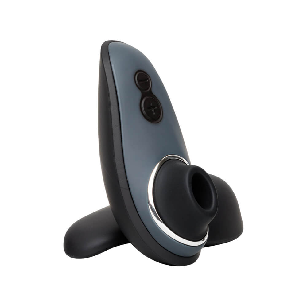 The Womanizer Liberty sex toy sitting upright, showcasing the two buttons on the handle of the toy to control the air suction sensations that come out of the tip. | Kinkly Shop