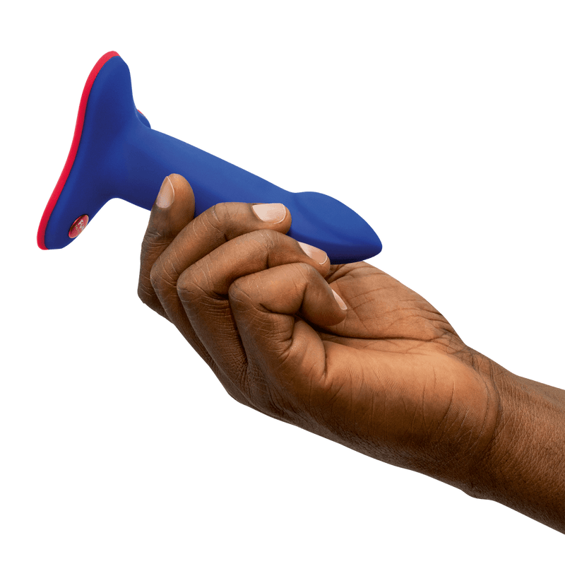 A person holds the Fun Factory Limba Flex. The dildo looks very short, with an insertable length that's about as long as the hand's fingers. It looks like it's about two fingers thick. | Kinkly Shop