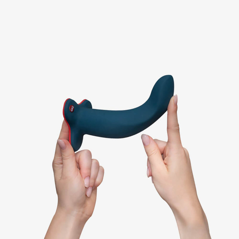 Two hands hold up the Fun Factory Limba Flex against a white background. The dildo is by-far the thickest of the three dildos. | Kinkly Shop