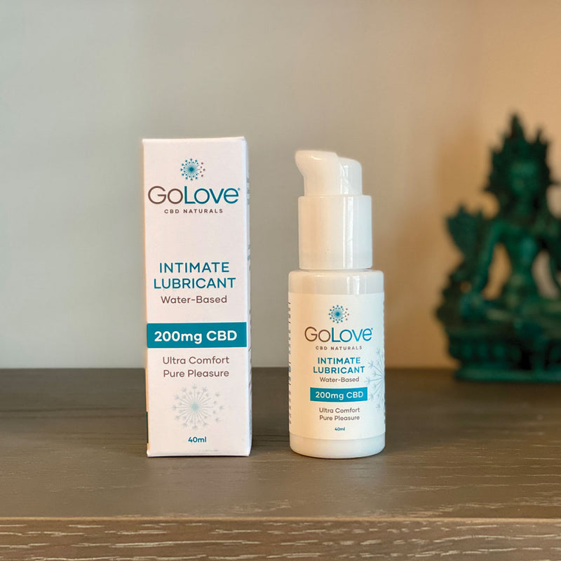 A bottle of the GoLove CBD Lube - 40ml next to its packaging sitting on a wooden table. | Kinkly Shop