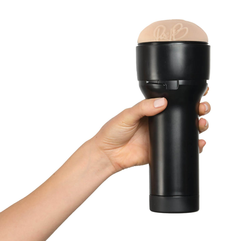 A hand holds the KIIROO FeelStars FeelRae Stroker. The hand that wraps around the stroker's handle looks really comfortable, like the stroker is easy to grip. | Kinkly Shop