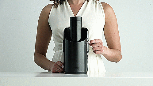 GIF shows a person standing behind the KIIROO KEON and Feel Stroker as it sits on a table. They press the buttons on both sides of the KEON and the stroker, which is stroking up and down, responds by getting faster in stroke speed and smaller in stroke length. This showcases how the manual mode works. | Kinkly Shop