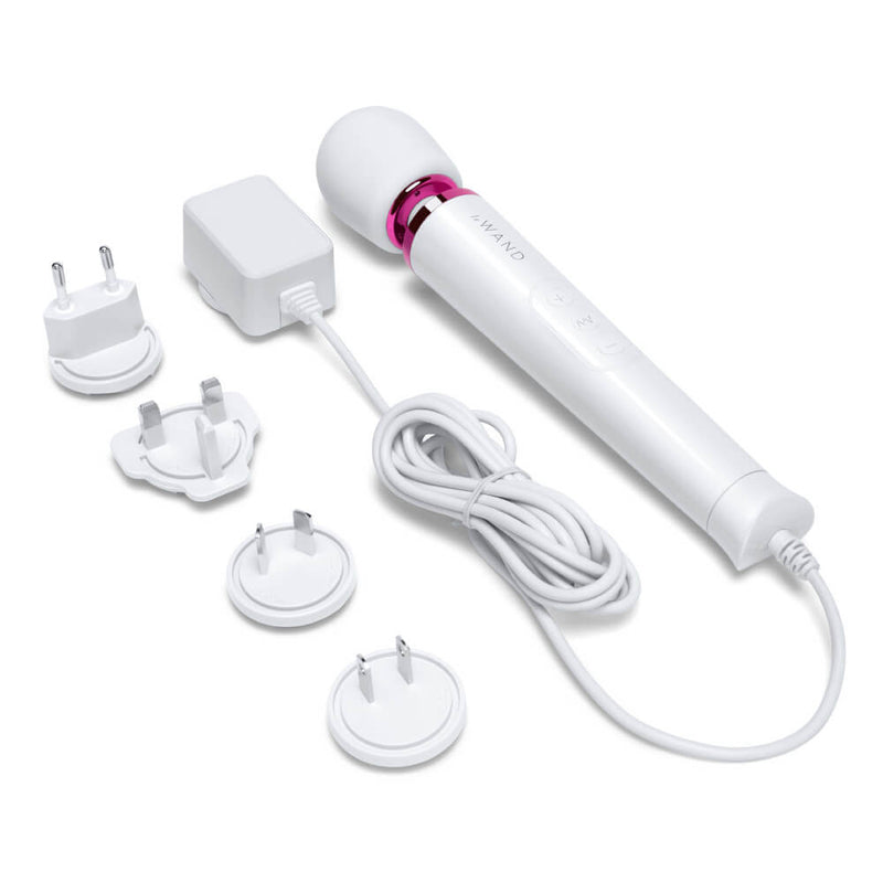 The Le Wand Petite Plug-In Massager in white with its power cord next to it. It also includes multiple outlet plates to help the wand massager work for your local electricity set-up, no matter where you're located. | Kinkly Shop
