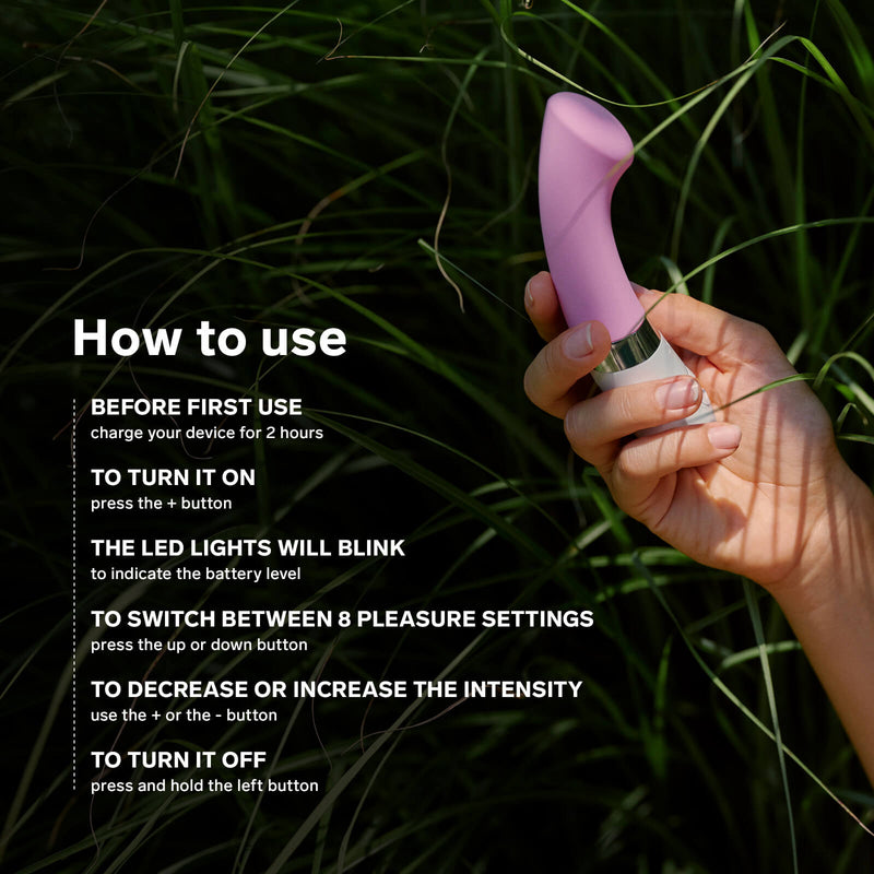 A hand holds the LELO GIGI 2 in some tall grass. Text on the image reads: "How to use. Before first use, charge your toy for 2 hours. To turn it on, press the + button. The LED lights will blink to indicate the battery level. To switch between 78 pleasure settings, press up or down. To decrease or increase intensity, use + or -. To turn it off, press and hold the left button." | Kinkly Shop