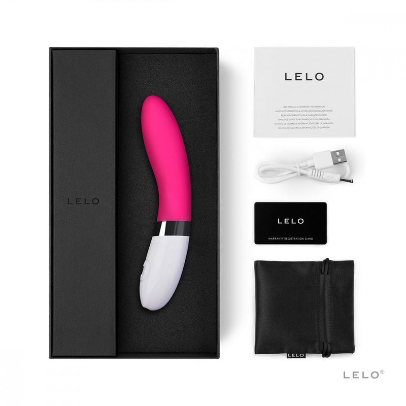 The LELO LIV 2 shown with everything that comes with the sex toy. There's the vibrator itself, the warranty card, the instruction manual, the charging cable, and a black drawstring storage bag. | Kinkly Shop
