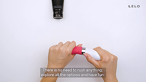 GIF showcasing two  hands holding the LELO LIV 2. The LELO LIV 2 is covered in lube, and it's slid into the fist of the other hand. The toy looks slender and glossy with the lube, and it slides easily against the person's hands. | Kinkly Shop