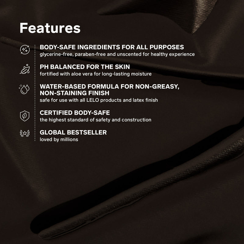 A list of features on a textured black background. Text includes: "Body-safe ingredients for all purposes. Glycerine-free. Paraben-free. Unscented. pH balanced for the skin. Fortified with aloe vera. Water-based formula for non-greasy, non-staining finish. Safe for use with all LELO products and latex finish. Certified body-safe. The highest standard of safety and construction. Global bestseller. Loved by millions." | Kinkly Shop