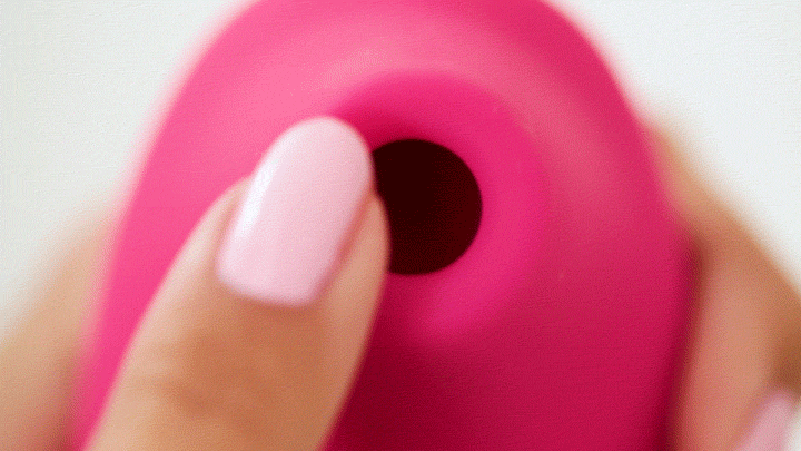 GIF shows a finger painted with light pink nail polish circling the clitoral suction tip at the tip of the LELO SONA. | Kinkly Shop