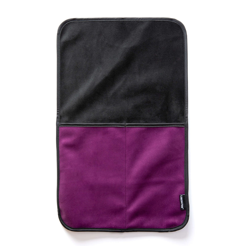 The Liberator Fascinator Sex Toy Caddy in Purple laying flat on a white surface. There are two deep pockets sewn into the base of the Caddy with a long, flat surface on top that can be tucked underneath any heavy objects. | Kinkly Shop
