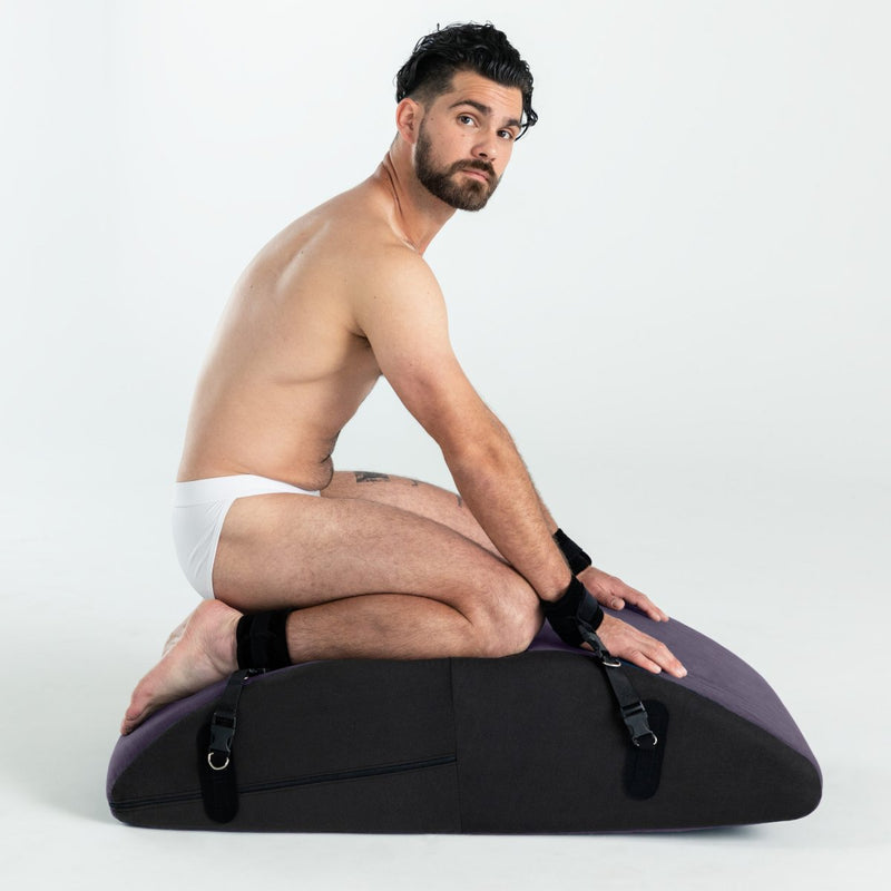 A person in their underwear is kneeling on top of the Liberator Scoop Rocker. Their wrists and ankles are bound to the Liberator Scoop Rocker's platform. | Kinkly Shop