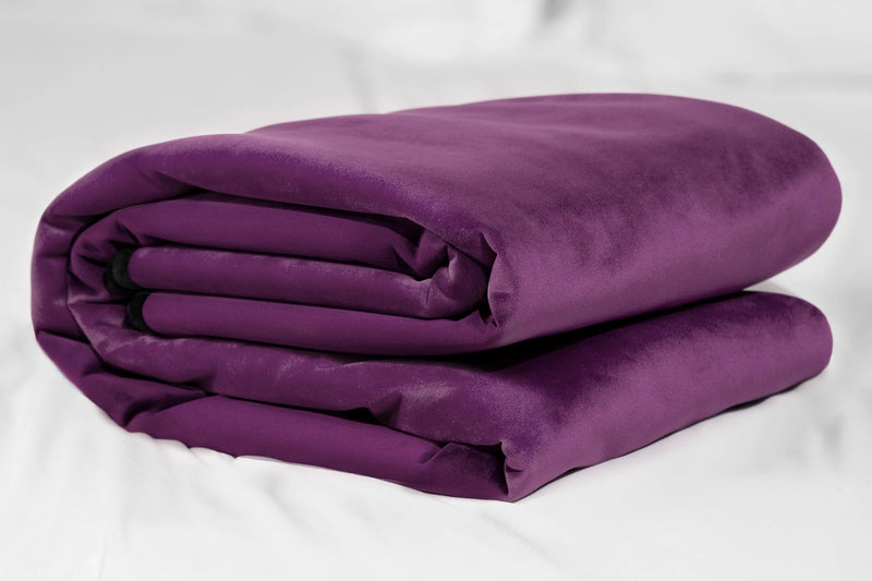 A folded up standard Liberator Fascinator Throw Purple blanket. It looks really plush and soft. It's surprisingly thick-looking. | Kinkly Shop