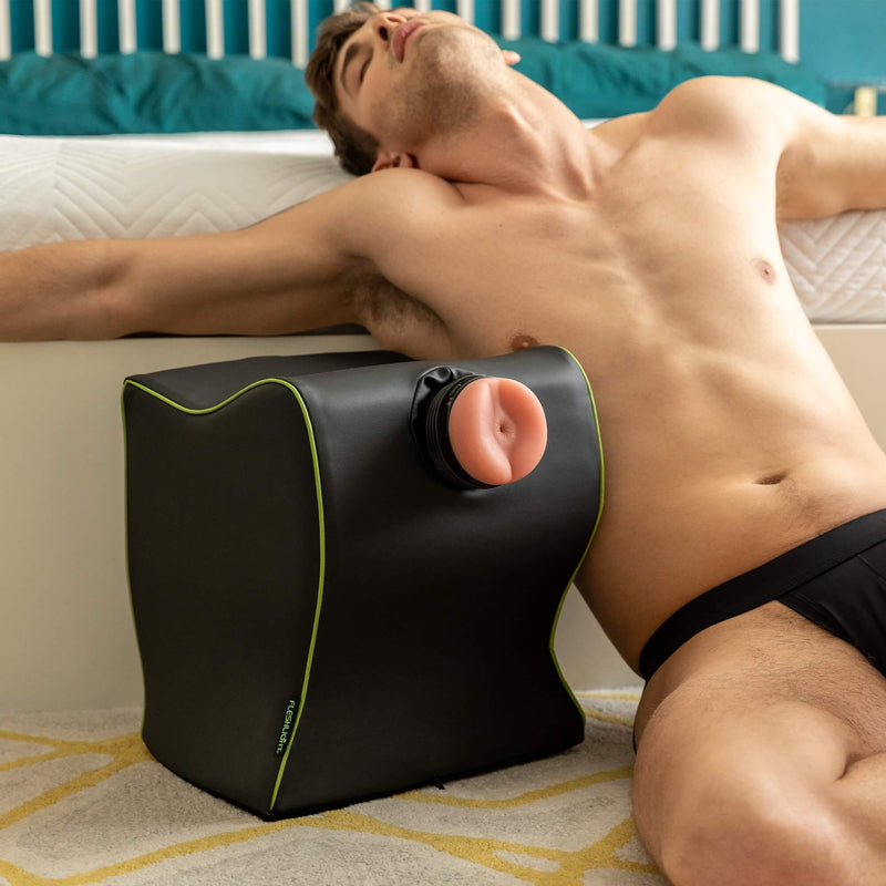 A Fleshlight stroker stuffed into the Liberator Fleshlight Top Dog. A person in their underwear is lounging next to the Top Dog with a relaxed, happy expression on their face. | Kinkly Shop