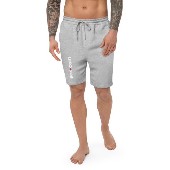 A person wears the Sex.com Men's Fleece Shorts in Grey. The Sex.com logo runs vertically down the right leg of the sweatpants. | Kinkly Shop