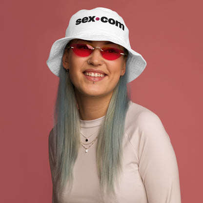 A person wears the Sex.com Organic Bucket Hat | Kinkly Shop