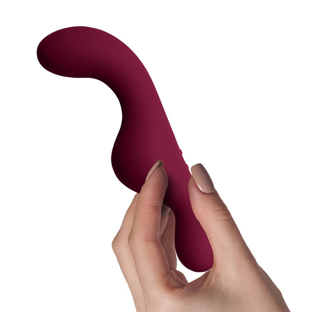 A hand holds the Rocks-Off Ruby Glow Blush. The vibrator's insertable portion looks to be about the thickness of two and a half fingers. | Kinkly Shop