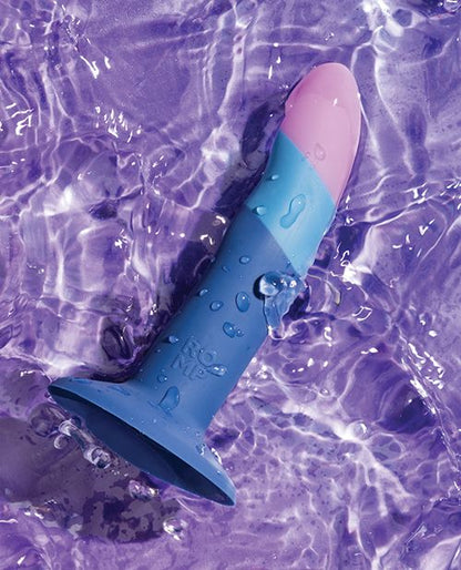 The ROMP Piccolo laying in a puddle of water with water droplets around it, showcasing its waterproof design. | Kinkly Shop