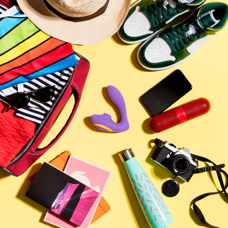 The ROMP Reverb surrounded by other summer vacation accessories. This lay flat image shows a yellow background with the ROMP Reverb surrounded by a digital camera, water bottle, beach towel, beach hat, shoes, portable speaker, and phone. The image has a fun, beach-ready vibe to it. | Kinkly Shop