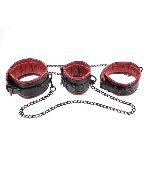 The three cuffs of the Sportsheets Chained and Tamed set curled up in a circle and sitting next to one another. This angle showcases the adjustable straps and buckles as well as the slightly padded interior of each one of the cuffs. | Kinkly Shop