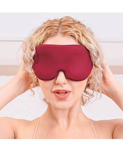A person wears the Sportsheets Saffron Blackout Blindfold. It takes up a lot of space on the person's face, showcasing how width and tall the blindfold is to block out all light. | Kinkly Shop