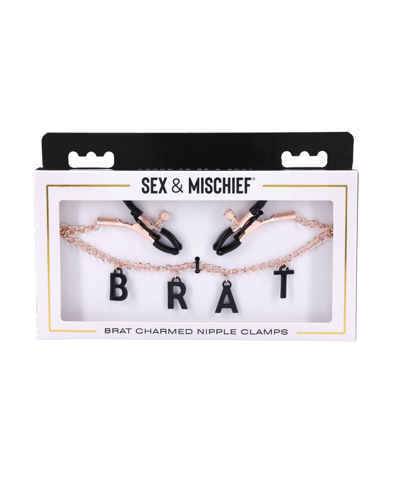 Packaging for the Sportsheets Brat Charmed Nipple Clamps. It's a cardboard box with a see-through window that showcases the "BRAT" lettering and the tip of the clamps. | Kinkly Shop