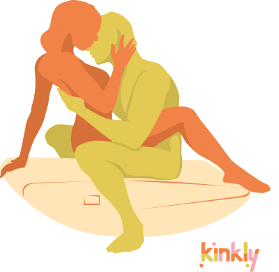 The Teeter Totter sex position. A couple embraces on top of the Liberator Scoop Rocker. The penetrating partner is sitting in the middle of the rocker, balanced, and the receiving partner is sitting on top of them, their legs on the edges of the Rocker to balance for penetration. | Kinkly Shop