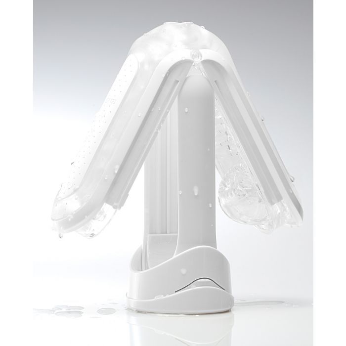 The Tenga Flip Zero upside down, balanced on top of the drying stand as water drips off the stroker. | Kinkly Shop