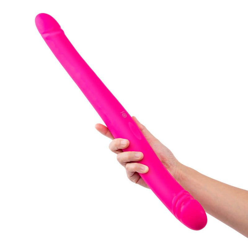 A person holds the Together Toy Duo Together while it's in a straight, unbent shape. It's extremely long. | Kinkly Shop