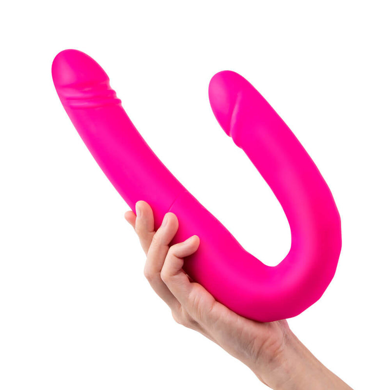 A hand holds the Together Toy Duo Together while it's bent into a "J" or "U" shape. The dildo looks formidable. It's thick enough that the person's hands don't easily wrap around the middle, and the dildo is much longer than the person's hand and forearm length. | Kinkly Shop