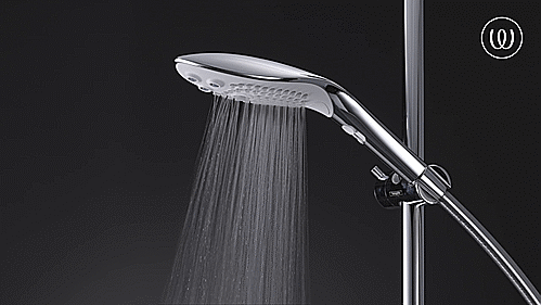 GIF showcases the Womanizer Wave attached to the shower, pouring out water in the Powder Rain setting. It looks like a broad, standard shower head. | Kinkly Shop