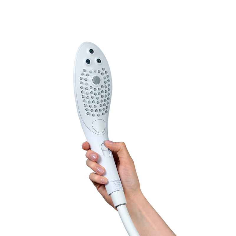 A hand holds the Womanizer Wave. With their hand in place, their thumb naturally rests on the intensity slider at the handle of the showerhead. | Kinkly Shop