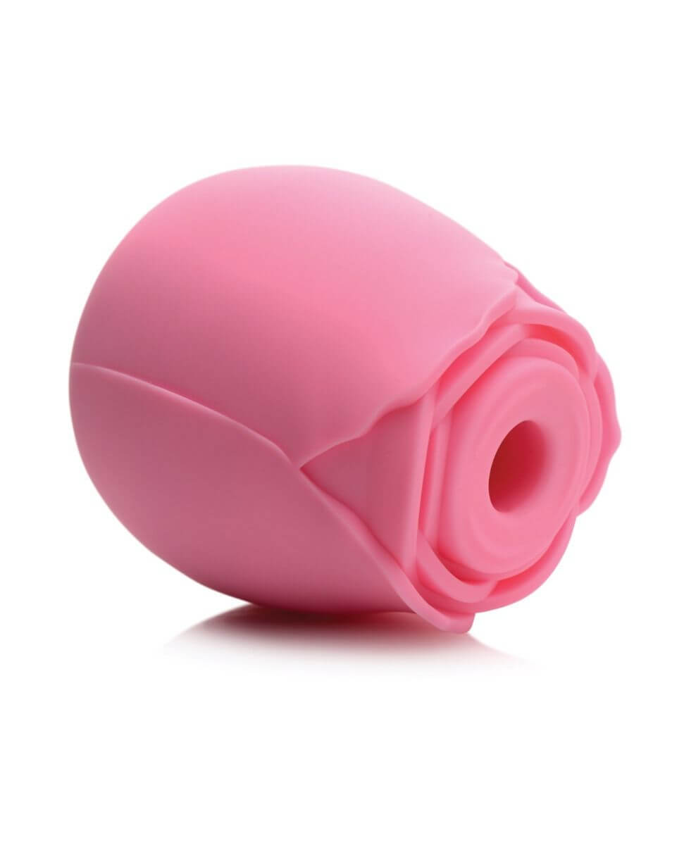 The XR Bloomgasm Rose  lays on its side. The open tip is pointed towards the camera, showing where a clitoris or nipple would be placed to enjoy the suction stimulation from the Rose. | Kinkly Shop