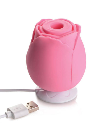 The pink XR Bloomgasm Rose sitting on top of its magnetic charging base. It simply perches on top, recharging, as it doesn't require a physical plug to be pushed into it in order to charge the vibrator. | Kinkly Shop