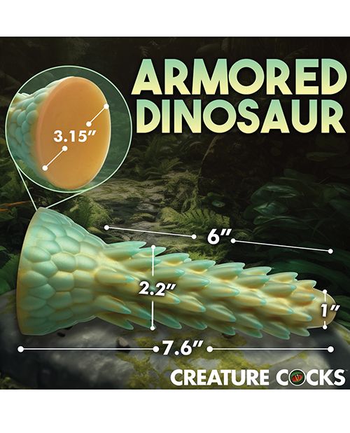 The Creative Cocks Stegosaurus lays in front of a forest image with measurements of the dildo superimposed over the different sides of the dildo. All measurements are included via text within the product description. | Kinkly Shop