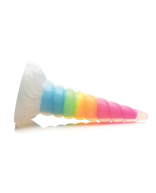 The Creature Cocks Uni Glow dildo is laid on its side. The base is thick and firm for safe anal use. | Kinkly Shop