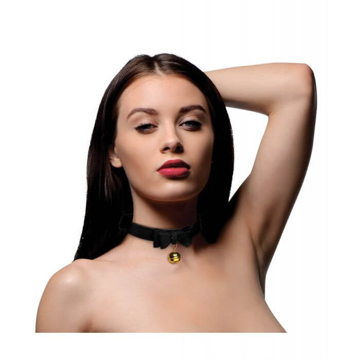 Person with long hair gives a seductive look while wearing the Master Series Kitty Cat Bell Collar. It's a thinner-width collar than many bdsm collars. | Kinkly Shop