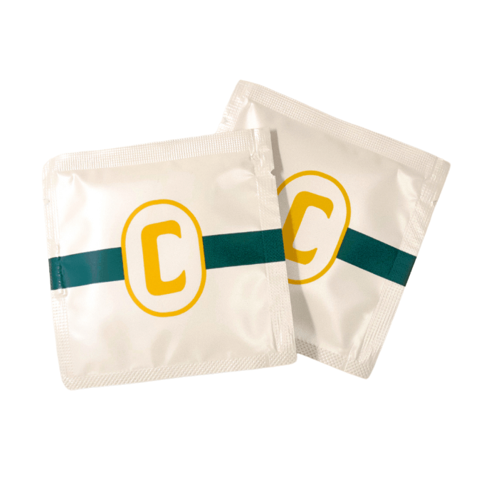 Close-up of the individually-wrapped Champ Body-Cleansing Wipes. Their small packets look like square condoms. | Kinkly Shop