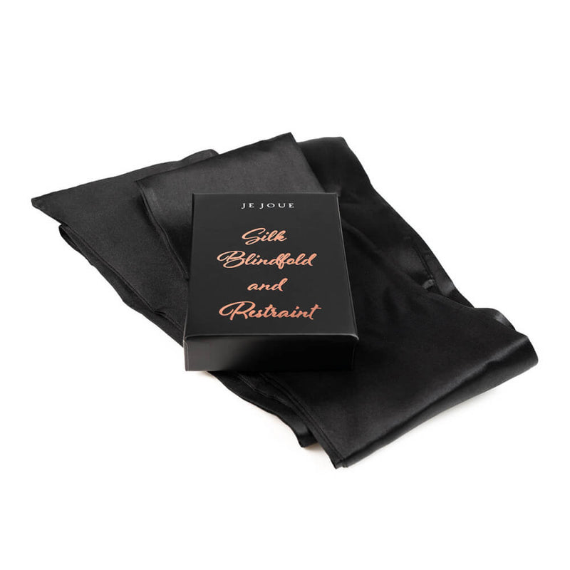 The black satin sash lays out underneath the box that it comes in within the Je Joue Naughty Collection kit. | Kinkly Shop